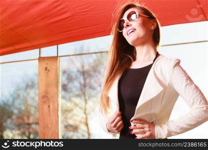 Fashionable girl long haired portrait. Stylish woman enlightened by sunbeams. Attractive elegant female, positive smiling face expression. Beauty smiling woman portrait