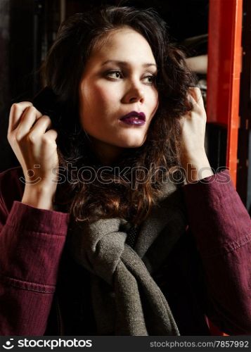 Fashionable girl standing front of the working machine - warehouse theme and close up image