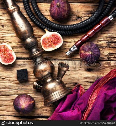 fashionable hookah in figs. Turkish smoking hookah with tobacco flavor of ripe figs in retro style.Tobacco background
