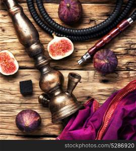 fashionable hookah in figs. Turkish smoking hookah with tobacco flavor of ripe figs in retro style.Tobacco background