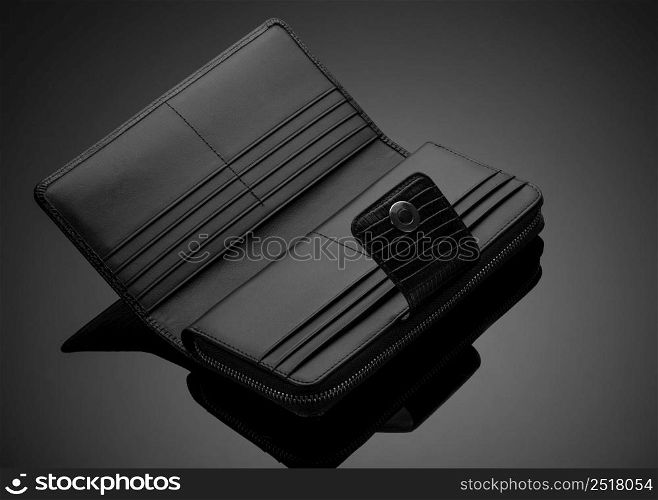 Fashionable leather men&rsquo;s wallet on a dark background. men&rsquo;s wallet on a black background