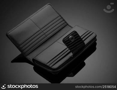 Fashionable leather men&rsquo;s wallet on a dark background. men&rsquo;s wallet on a black background