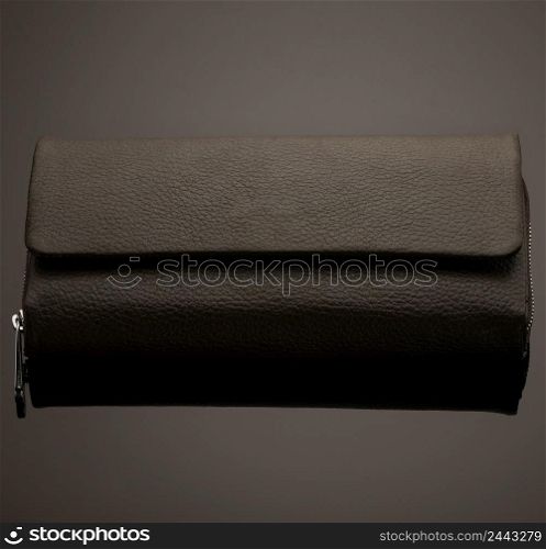 Fashionable leather men&rsquo;s wallet on a dark background. wallet on a black background