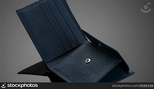 Fashionable leather men&rsquo;s wallet on a dark background. wallet on a black background