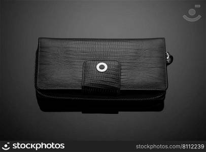 Fashionable leather men’s wallet on a dark background. men’s wallet on a black background