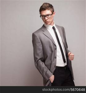 Fashionable male model posing in grey suit
