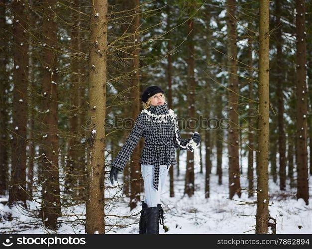 Fashionable mature adult woman wearing winter clothes, rural scene, forest on background