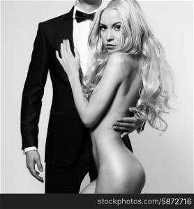 Fashionable photo of beautiful naked lady and man in suit