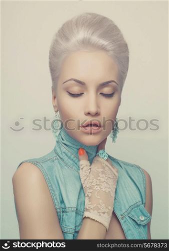 Fashionable photo of young stylish blonde in denim vest