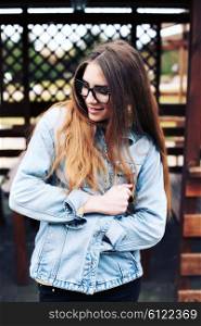 Fashionable portrait of a beautiful hipster girl. Denim stylish clothes. Glamorous Lady fashion trends.