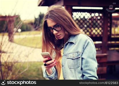 Fashionable portrait of a beautiful hipster girl. Denim stylish clothes. Glamorous Lady fashion trends.