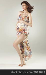 Fashionable pregnant lady wearing flowered dress