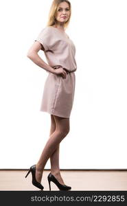 Fashionable pretty woman wearing elegant casual pink tunic dress presenting stylish elegant outfit.. Female wearing casual pink tunic dress