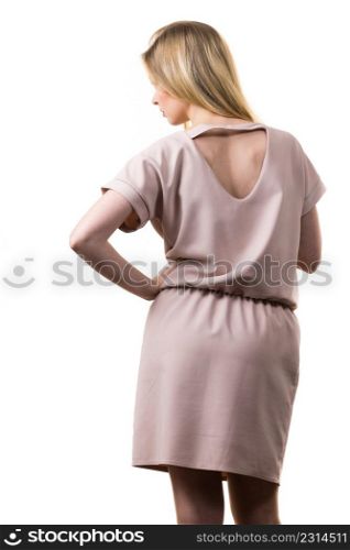 Fashionable pretty woman wearing elegant casual pink tunic dress presenting stylish elegant outfit. Back view with triangle shaped hole.. Female wearing casual pink tunic dress