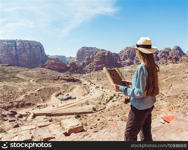 Fashionable woman, exploring the sights of the ancient, fabulous city of Petra in Jordan. Colorful photos. Concept of leisure, vacation and travel. Woman exploring the sights city of Petra