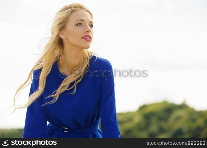 Fashionable woman wearing blue navy shirt perfect for summer. Fashion model outdoor photo shoot. Fashion model wearing blue navy shirt