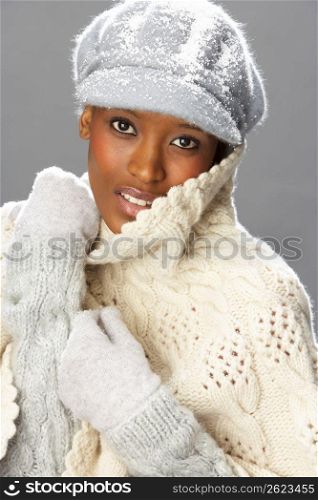 Fashionable Woman Wearing Knitwear And Cap In Studio