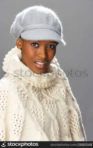 Fashionable Woman Wearing Knitwear And Cap In Studio