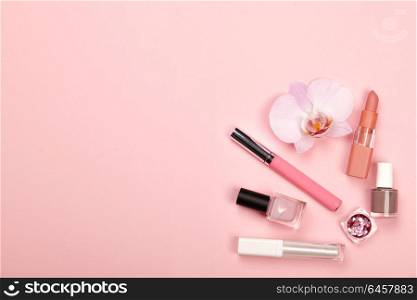 Fashionable Women&rsquo;s Cosmetics and Accessories. Falt Lay. Nail Polish and Lipstick. Beautiful Orchid Flower. Make Up Cosmetic items Top View