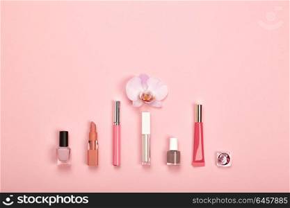 Fashionable Women&rsquo;s Cosmetics and Accessories. Falt Lay. Nail Polish and Lipstick. Beautiful Orchid Flower. Make Up Cosmetic items Top View