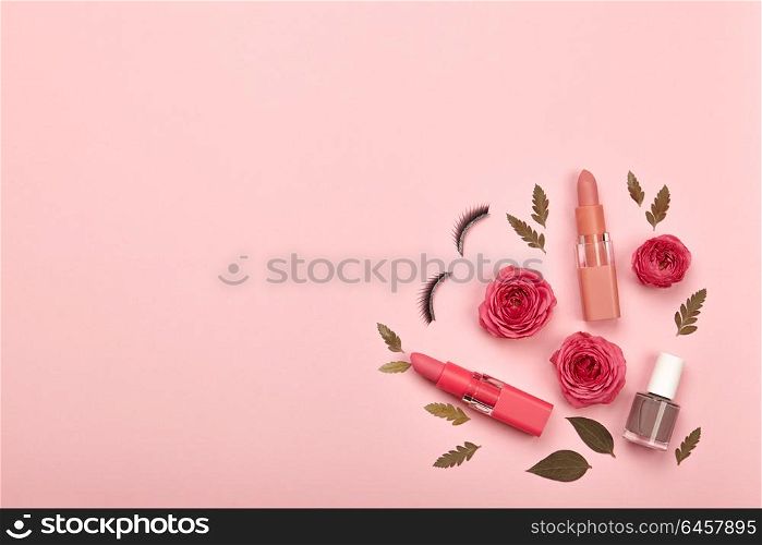 Fashionable Women&rsquo;s Cosmetics and Accessories. Falt Lay. Nail Polish and Lipstick. Beautiful Roses Flower. Make Up Cosmetic items Top View. False eyelashes