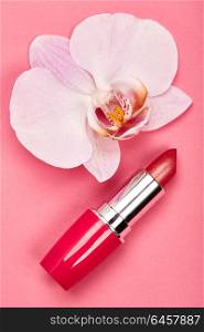 Fashionable Women&rsquo;s Cosmetics and Accessories. Falt Lay. Red Lipstick. Beautiful Orchid Flower. Make Up Cosmetic items Top View