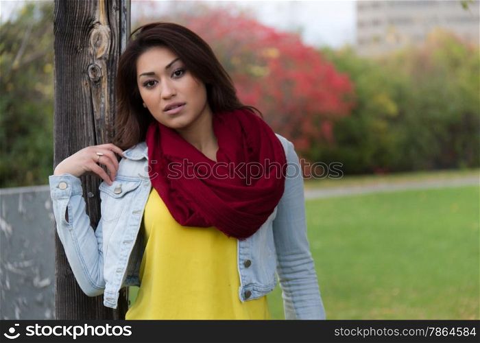 Fashionable young woman posing in a park