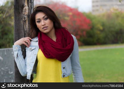 Fashionable young woman posing in a park