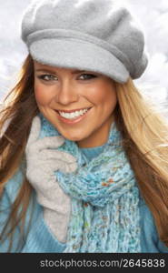 Fashionable Young Woman Wearing Cap And Knitwear In Studio