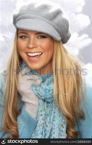 Fashionable Young Woman Wearing Cap And Knitwear In Studio