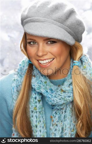 Fashionable Young Woman Wearing Cap And Knitwear In Studio