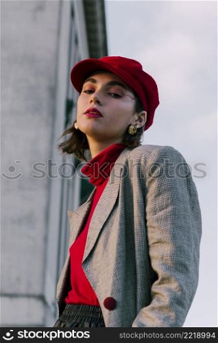 fashionable young woman with red cap looking camera
