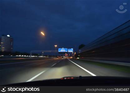 fast driving car on highway at dusk
