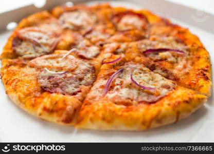 fast food and unhealthy eating concept - close up of sliced takeaway pizza in paper box. close up of sliced takeaway pizza in paper box