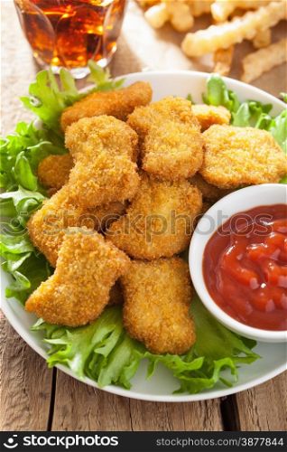 fast food chicken nuggets with ketchup, french fries, cola