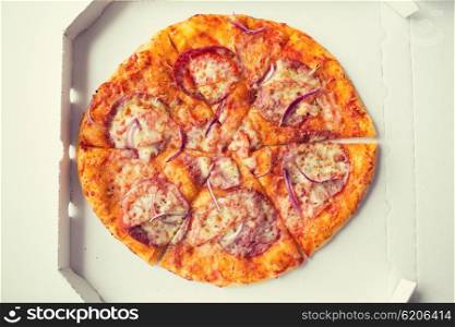 fast food, italian kitchen and eating concept - close up of pizza in paper box on table