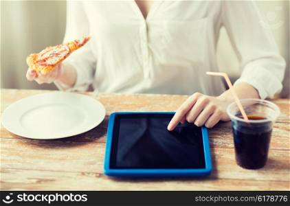 fast food, people, technology and diet concept - close up of woman hands with tablet pc computer, pizza and coca cola counting calories at table