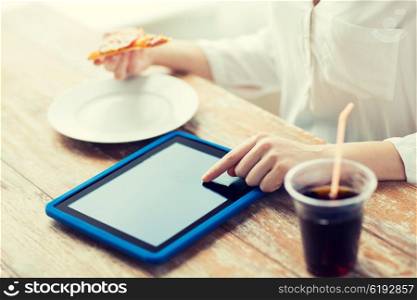 fast food, people, technology and diet concept - close up of woman with tablet pc computer, pizza and cola counting calories at table