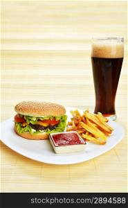 Fast food tasty hamburger with french fries and cola