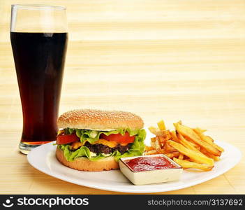 Fast food tasty hamburger with french fries and cola