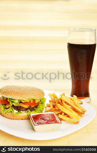 Fast food tasty hamburger with french fries and cola