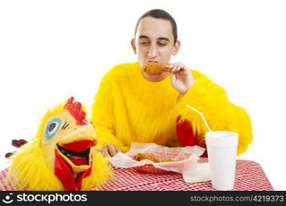 Fast food worker in chicken costume takes a break to eat dinner. Isolated on white.