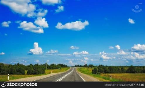 fast highway in forest under clean blue sky