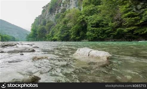 Fast mountain river with stones and rocks around