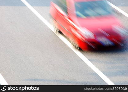 Fast moving red car with blurred effect