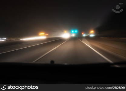 Fast night driving on highway, view from inside of a car