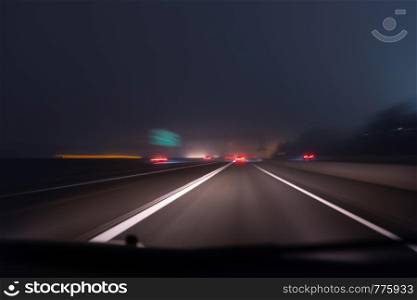 Fast night driving on highway, view from inside of a car