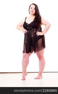 Fat adult woman wearing black lace lingerie nightwear. Plus size female in full length. Big body, underwear concept.. Full body of fat mature woman in lingerie