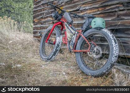 fat bike and rustic mountain cabin in northern Colorado, late fall or winter scenery