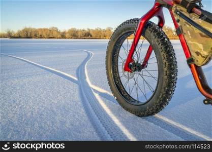 fat bike, footprints and shadows on a frozen lake in northern Colorado